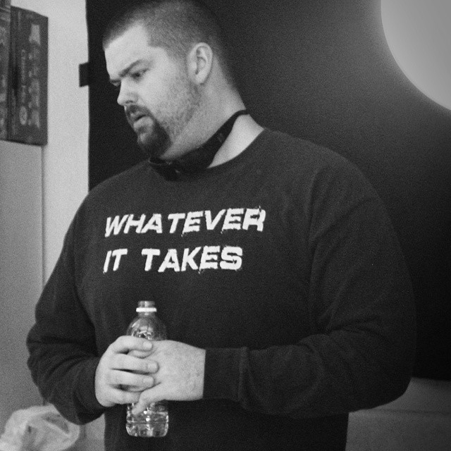 black and white photo of jl faverio wearing his whatever it takes shirt